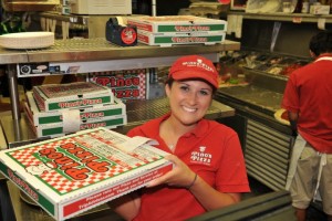 woman worker of Pino's Pizza holding box of Pino's Pizza of OCMD